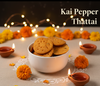 Bowl of Kai Pepper Thattai with decorative lights and flowers on a dark background